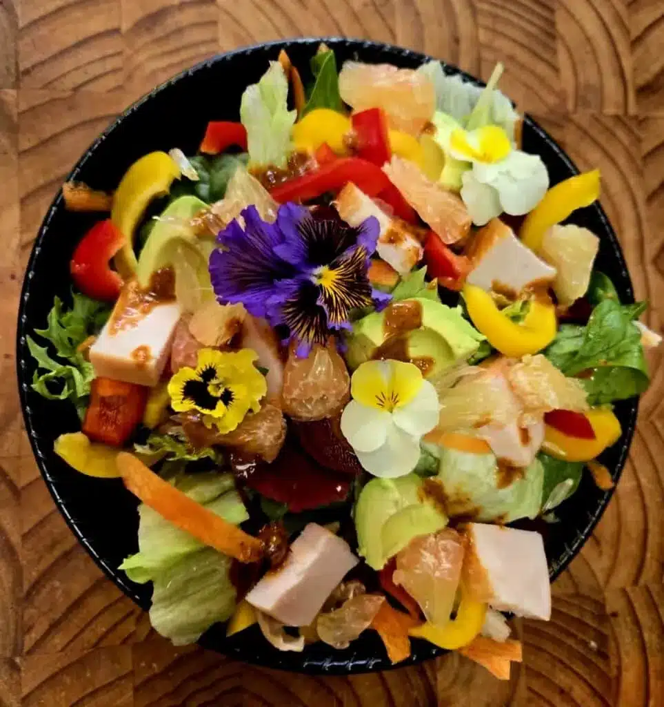 Refreshing Thai salad with fresh greens and edible flowers.